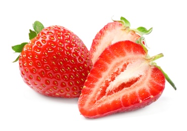 Delicious whole and cut strawberries on white background