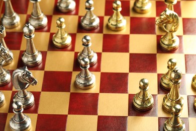 Wooden chessboard with different beautiful game pieces