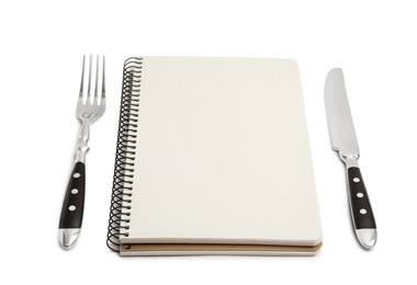 Blank recipe book and cutlery on white background. Space for text