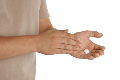 Man applying cream on hands against white background, closeup