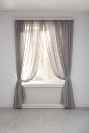Window with beautiful curtains in empty room