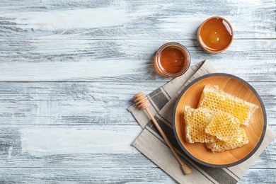 Flat lay composition with fresh honey on wooden background
