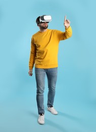 Man using virtual reality headset on light blue background