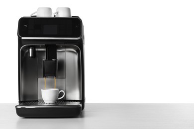 Making coffee with modern espresso machine on table against white background. Space for text