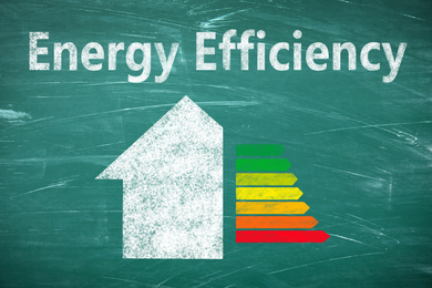 Energy efficiency concept. Part of house and colorful chart drawn on chalkboard