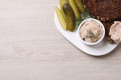 Photo of Delicious lard spread, bread and pickles on wooden table, top view. Space for text