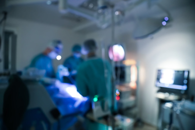 Blurred view of doctors operating patient in surgery room