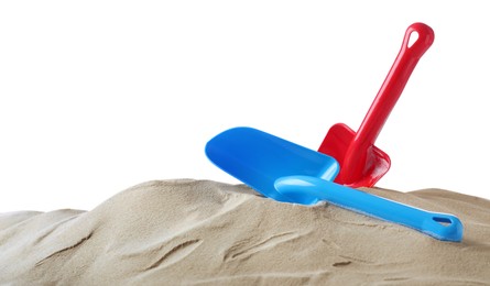 Light blue and red plastic toy shovels on pile of sand