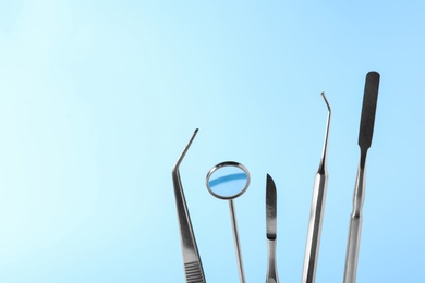 Set of different dentist tools on color background, closeup. Space for text