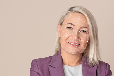 Facial recognition system. Mature woman with biometric identification scanning grid on beige background, space for text