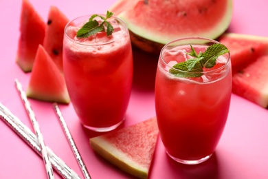 Tasty watermelon drink with mint on pink background, closeup