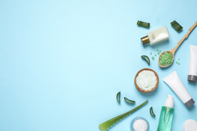 Photo of Flat lay composition with aloe vera and cosmetic products on light blue background. Space for text