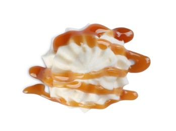 Photo of Delicious fresh whipped cream with caramel sauce isolated on white, top view