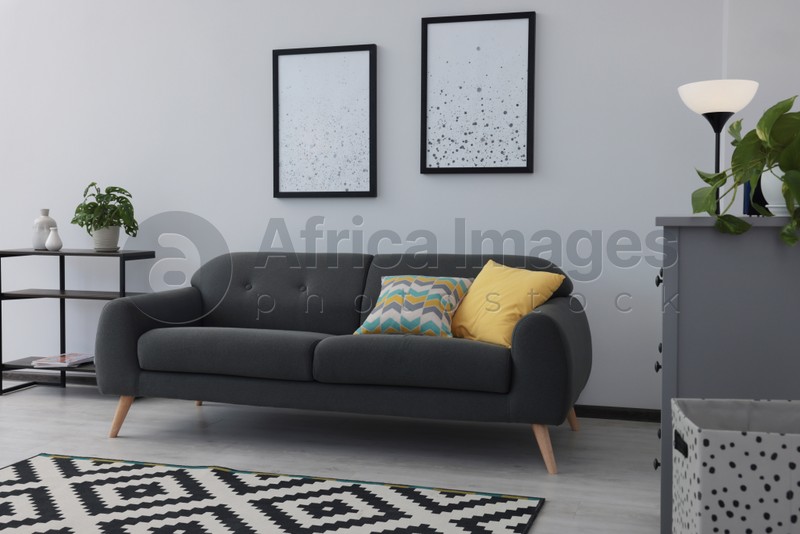 Beautiful living room interior with stylish grey sofa