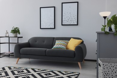 Beautiful living room interior with stylish grey sofa