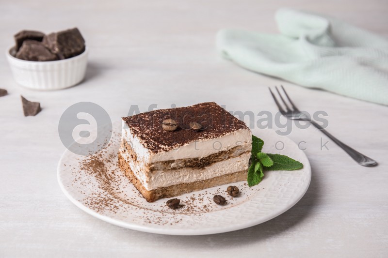 Tiramisu cake with coffee beans on table
