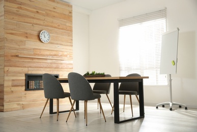 Modern meeting room interior with large table and chairs