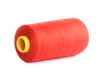 Spool of red sewing thread isolated on white
