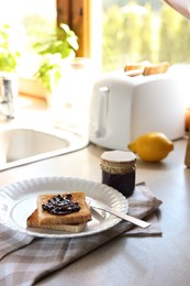 Tasty toasts with jam on countertop in kitchen, space for text