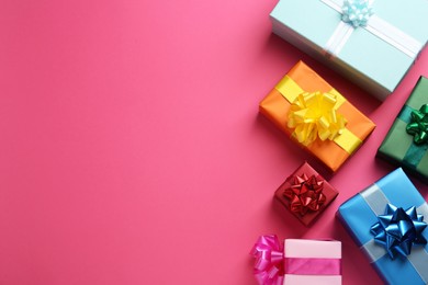 Many colorful gift boxes on pink background, flat lay. Space for text