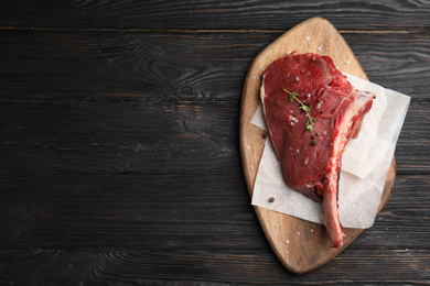 Fresh raw beef cut on wooden table, top view. Space for text