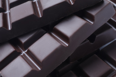 Delicious dark chocolate as background, closeup view