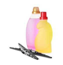 Bottles of windshield washer fluids and wipers on white background
