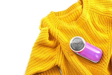 Photo of Modern fabric shaver and woolen sweater on white background, top view