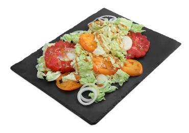 Slate plate of delicious salad with Chinese cabbage, tomatoes and onion on white background