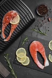 Cooking salmon. Grill, fresh fish steaks, lemon and spices on dark table, flat lay