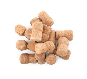 Heap of sparkling wine corks on white background, top view