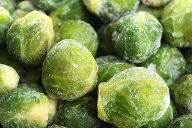 Frozen Brussels sprouts as background, closeup. Vegetable preservation