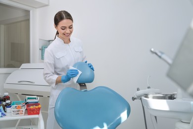Professional dentist in white coat cleaning workplace  indoors