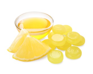 Many color cough drops, slice of orange and honey on white background