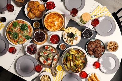 Brunch table setting with different delicious food indoors, top view