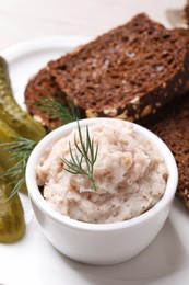 Photo of Delicious lard spread, bread and pickles on table, closeup