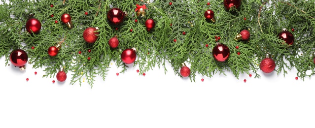 Photo of Thuja branches with Christmas decorations on white background, flat lay