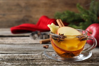Hot mulled cider on wooden table, space for text