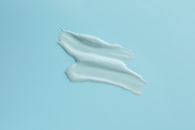 Samples of face mask on light blue background, top view