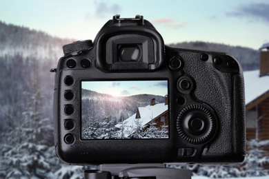 Image of Recording beautiful view of snowy forest on professional video camera