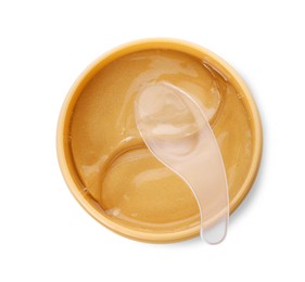 Under eye patches in jar with spatula isolated on white, top view. Cosmetic product
