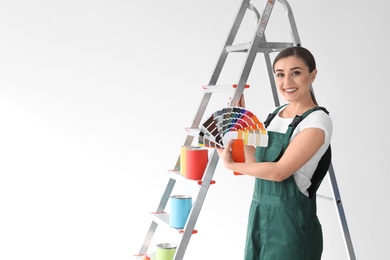 Female decorator with color palette on white background