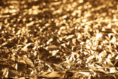 Crumpled gold foil as background, closeup view
