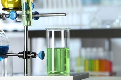 Image of Laboratory glassware with different liquid samples, focus on beaker