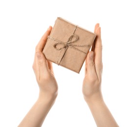 Woman holding parcel wrapped in kraft paper on white background, closeup