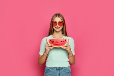 Beautiful girl with slice of watermelon on crimson background