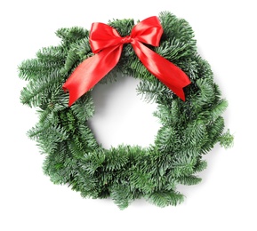 Photo of Christmas wreath made of fir tree branches with red ribbon isolated on white