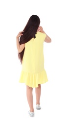 Brunette woman in yellow dress on white background, back view
