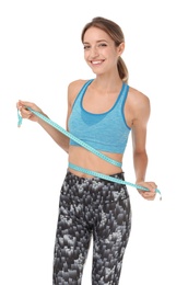 Happy slim woman in sportswear with measuring tape on white background. Positive weight loss diet results