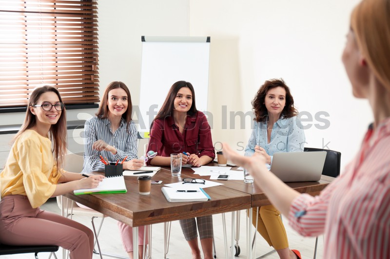 Female professional business trainer working with ladies in office. Women power concept
